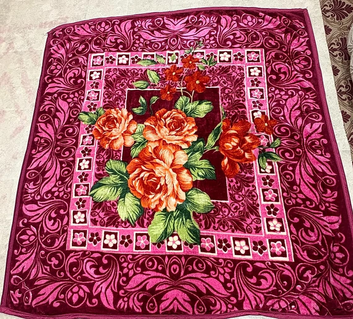 Full spread view of deep wine floral embossed mink blanket