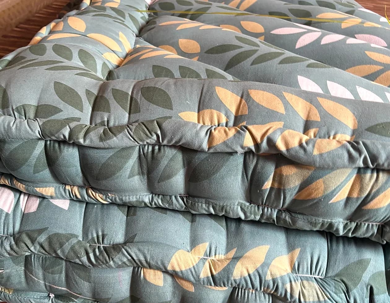 Quilted sage botanical traditional gadda with piped border