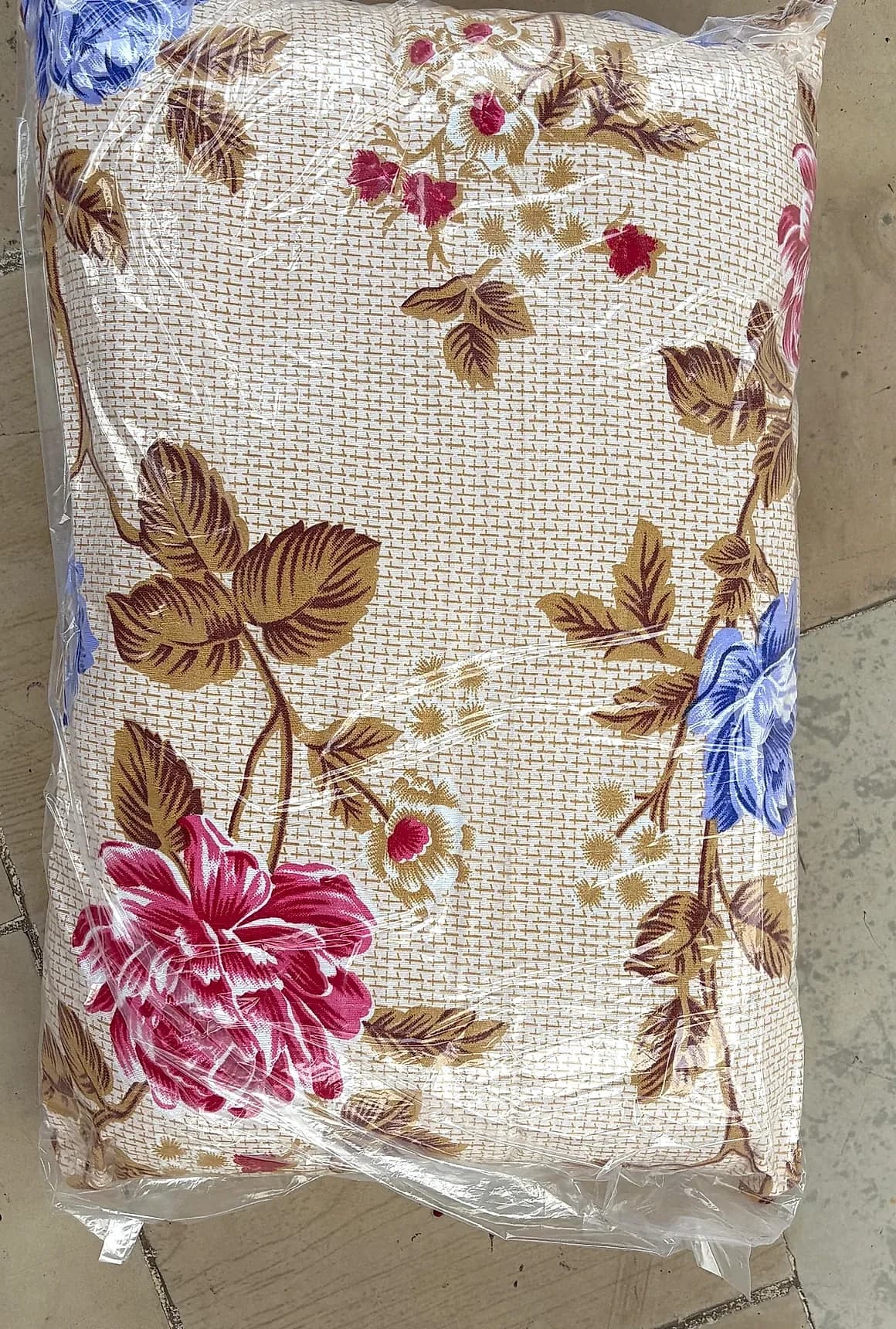 Retail packaged floral pillow in clear protective sleeve with Diamond Fibre branding