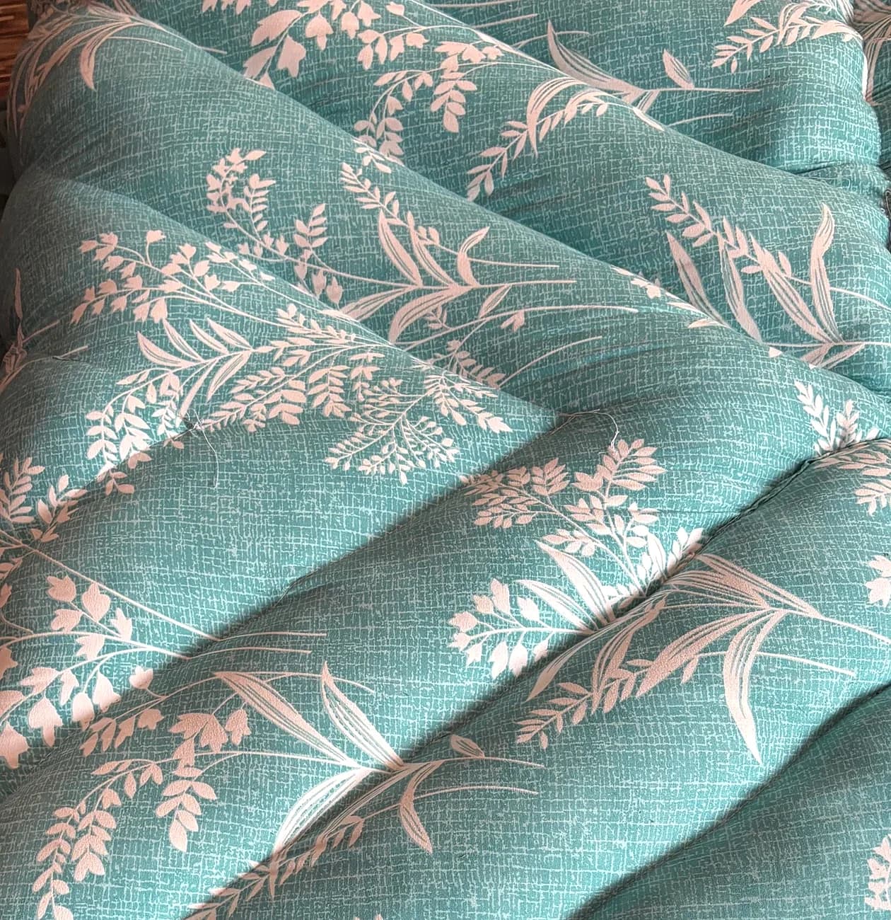 Close-up detail of dense diagonal channel quilting stitch