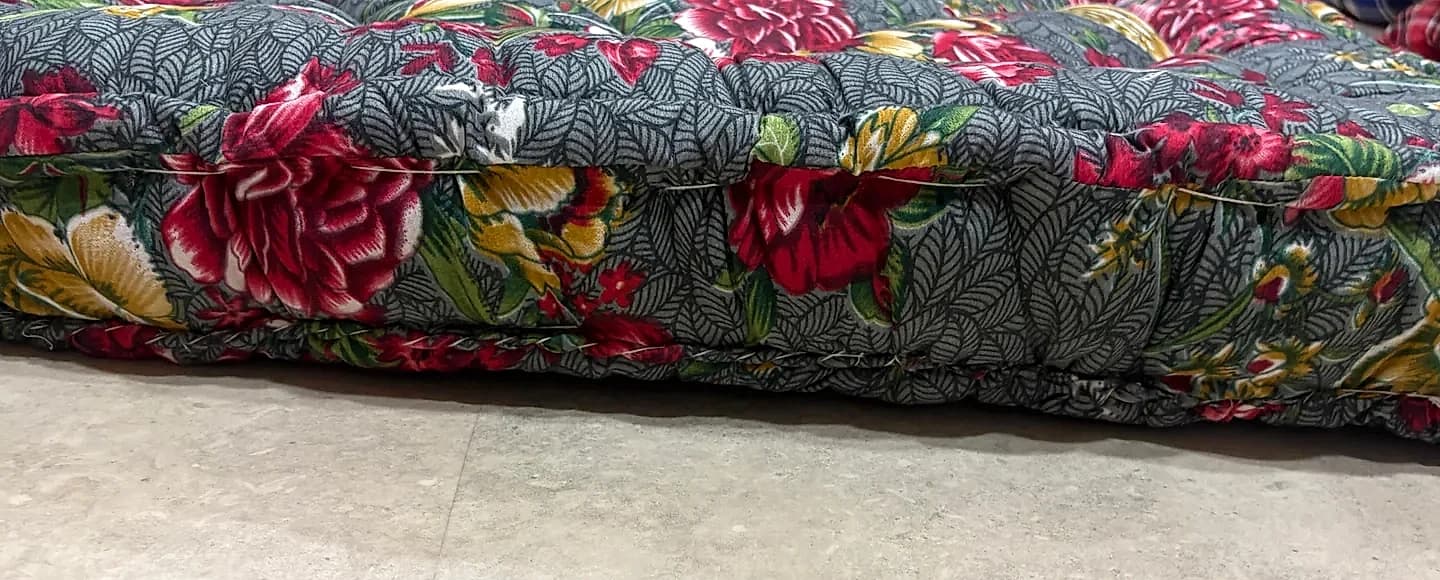 Reinforced piped edge border and multi-layer tufting construction